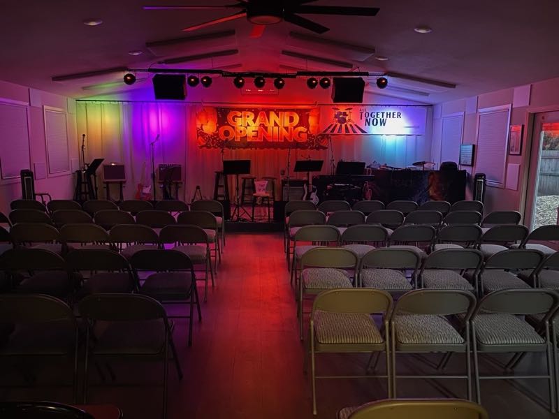 The Granite Shoals concert room set with rows of chairs facing the lit stage