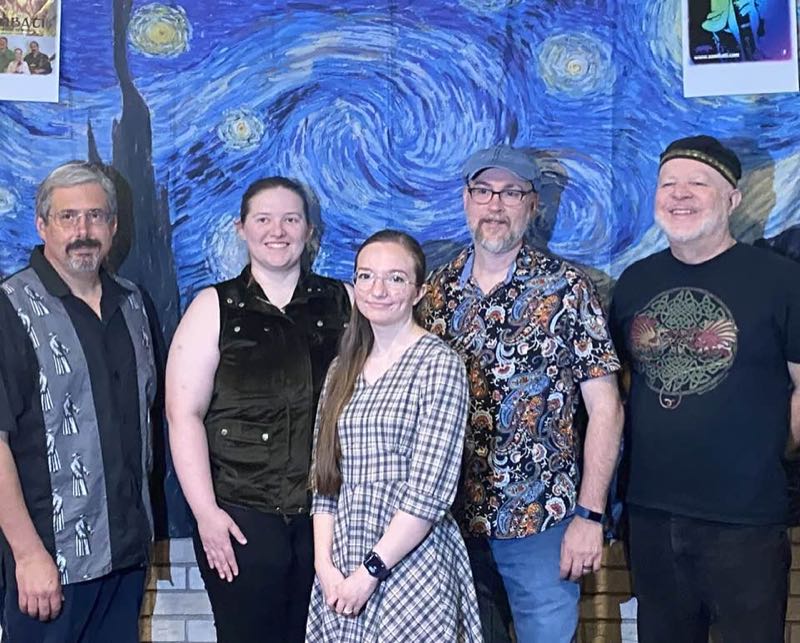 band Sombati posing in front of starry night backdrop